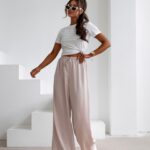 Spodnie z wyższym stanem dzwony NAVEEN OLAVOGA beżowe