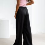 Spodnie z wyższym stanem dzwony NAVEEN OLAVOGA czarne